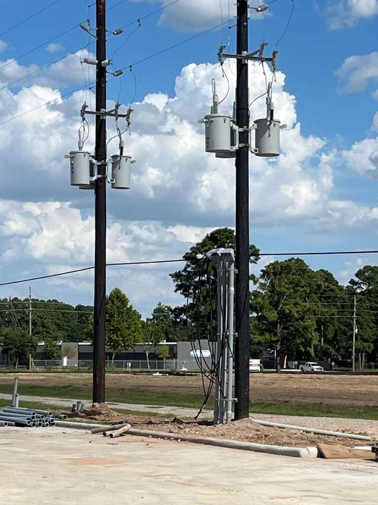 Utility poles with transformers and risers