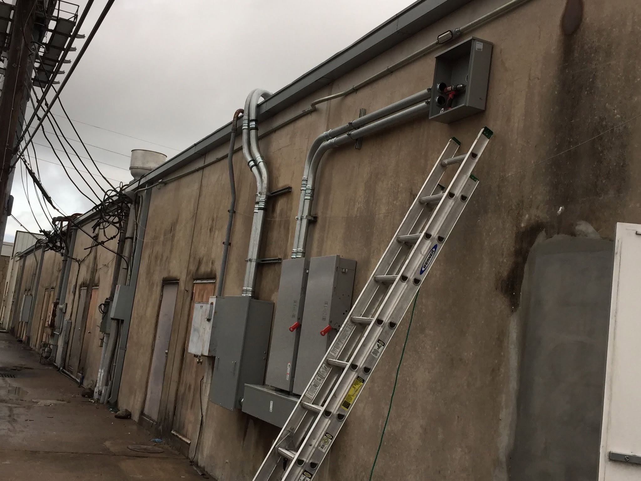 Conduit runs and disconnects on building exterior