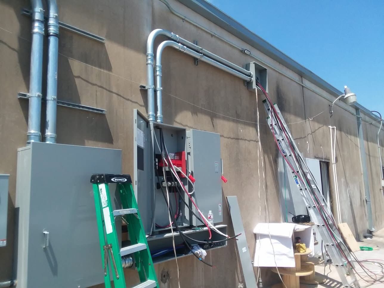 Service conductors pulled through overhead conduits